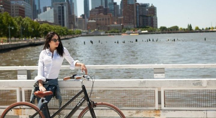 Woman Standing With Bicycle 900x400